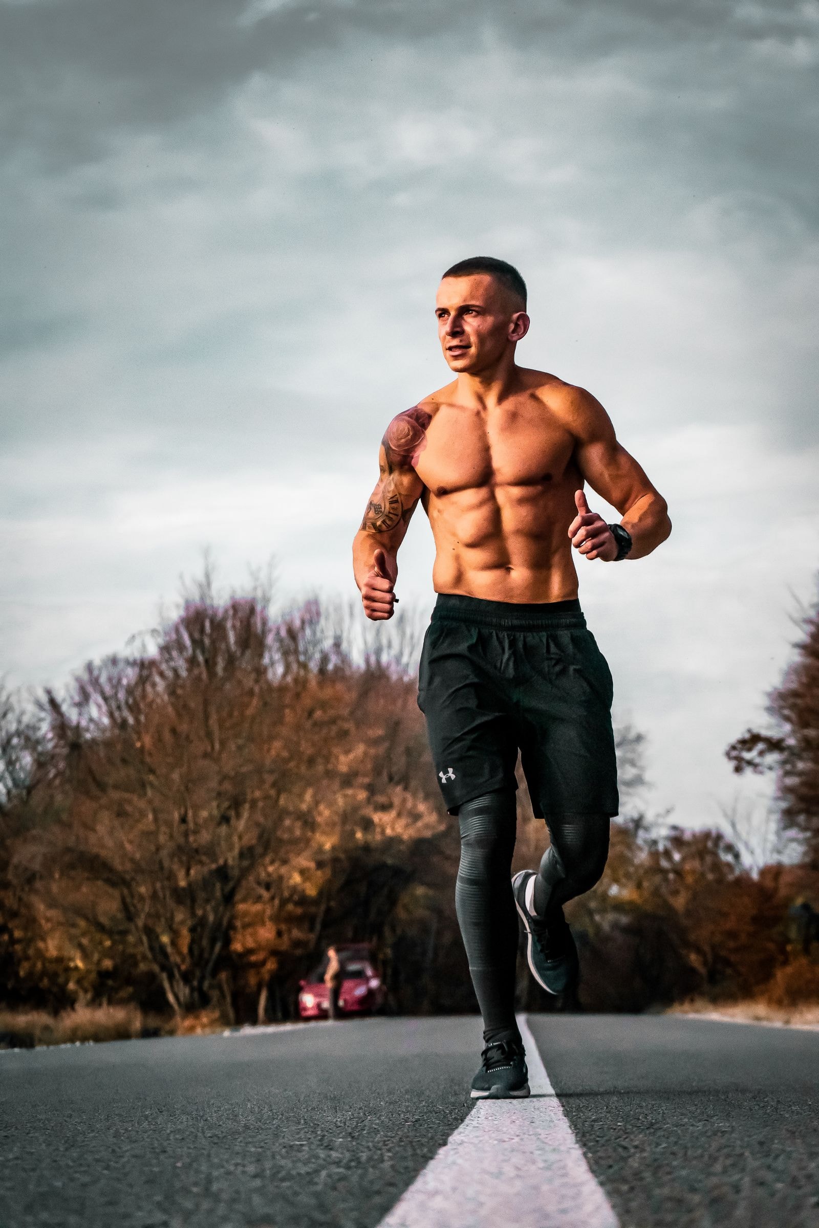 A runner on an open road under a grey sky