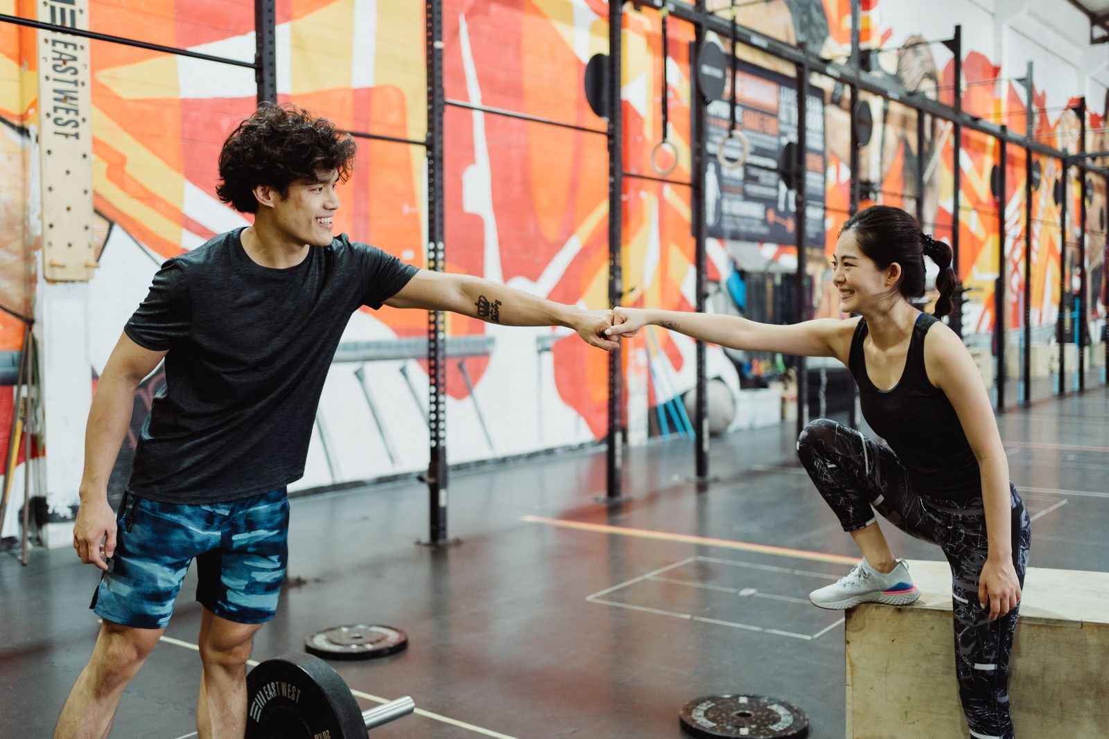 Two training partners bumping fists in the gym