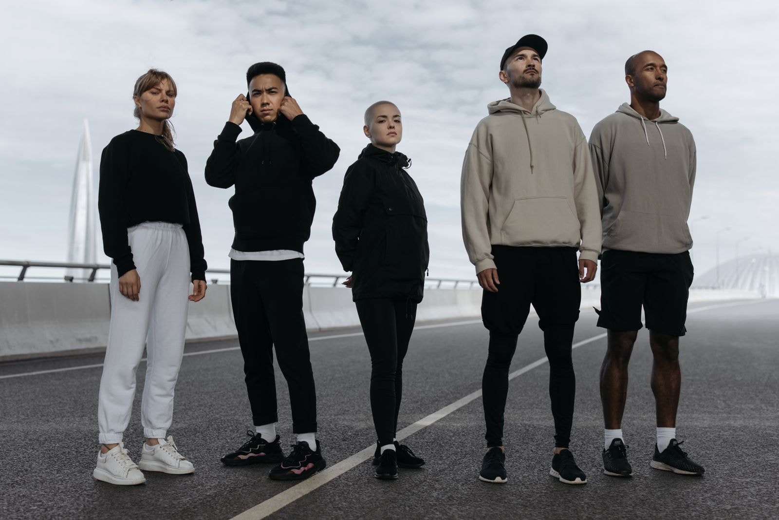 A crew of five standing on an empty road