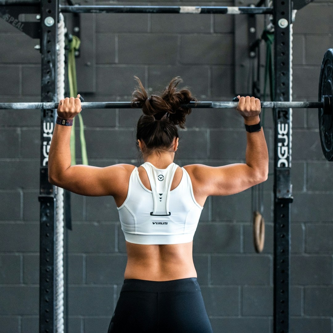 An athlete gripping a bar with chalked hands